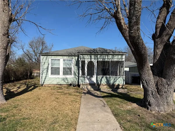 a view of a house with backyard sitting area and porch