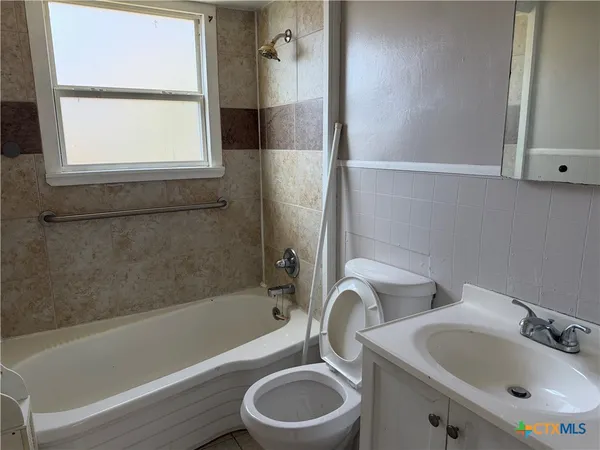a bathroom with a sink toilet and bathtub