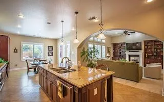 a kitchen with counter top space and wooden floor