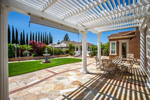 a view of a porch with furniture and garden