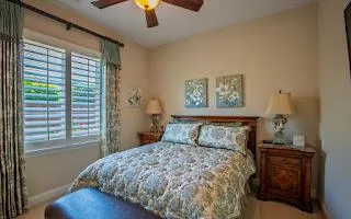 a bedroom with a bed and a window