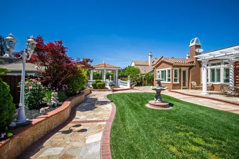 a view of an house with swimming pool garden and patio