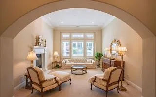 a living room with furniture and a chandelier