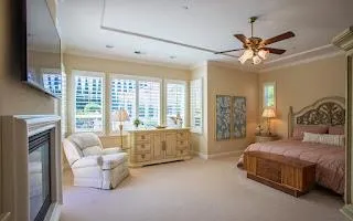 a spacious bedroom with a bed and a large window