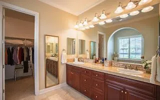 a bathroom with a sink a vanity and a mirror