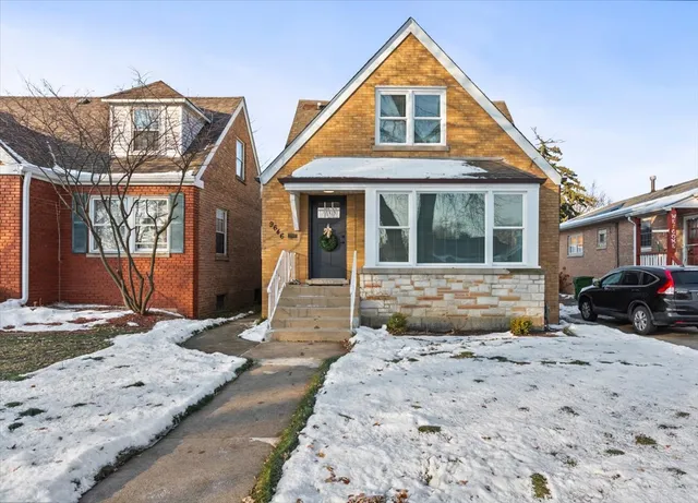a front view of a house with a yard covered in snow