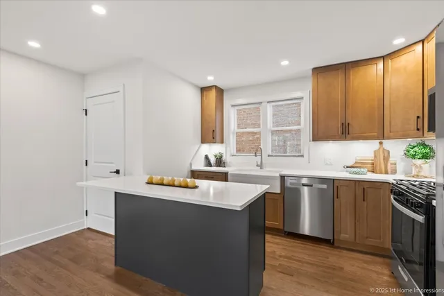 a kitchen with stainless steel appliances granite countertop a sink and dishwasher a stove with wooden floor