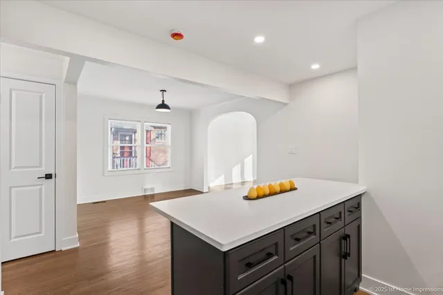 a kitchen with a sink cabinets and wooden floor