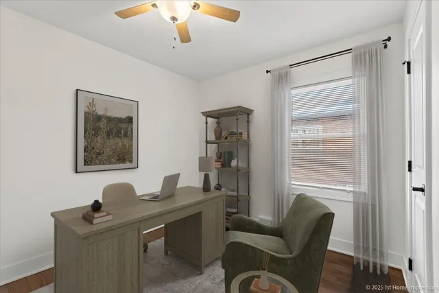 a view of a workspace with furniture and a window