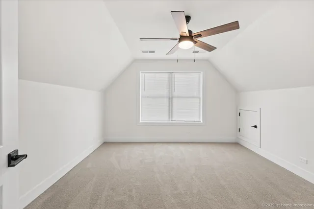 an empty room with ceiling fan and window