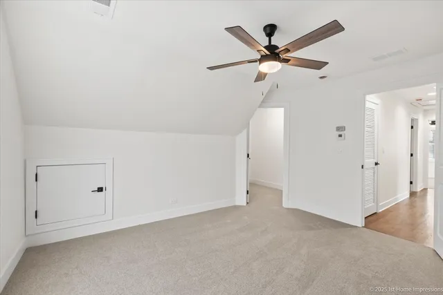 an empty room with closet and windows