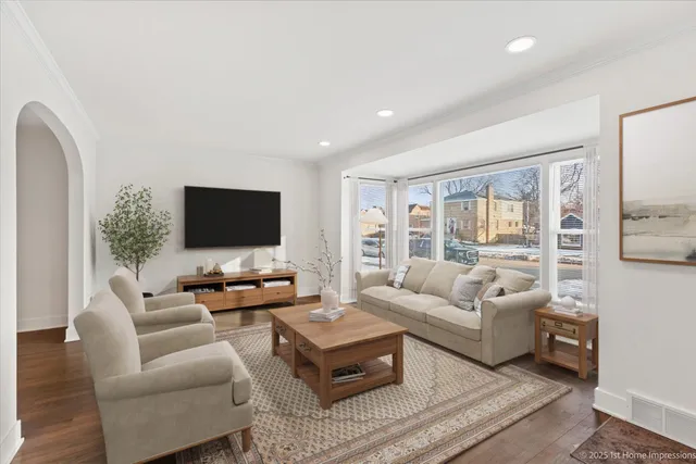 a living room with furniture wooden floor and a flat screen tv