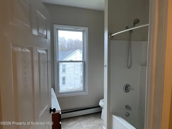 a bathroom with a tub and shower
