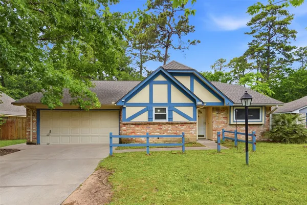 a front view of a house with a yard and trees