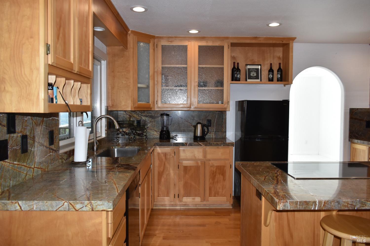 7490 Walnut Lane Lower Lake, CA 95457 - Photo 11 of 44 a kitchen with stainless steel appliances granite countertop a sink and a stove