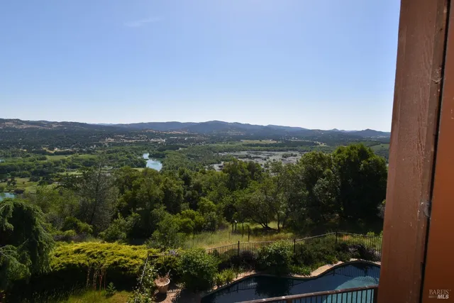 a view of a deck with mountain view and wooden floor
