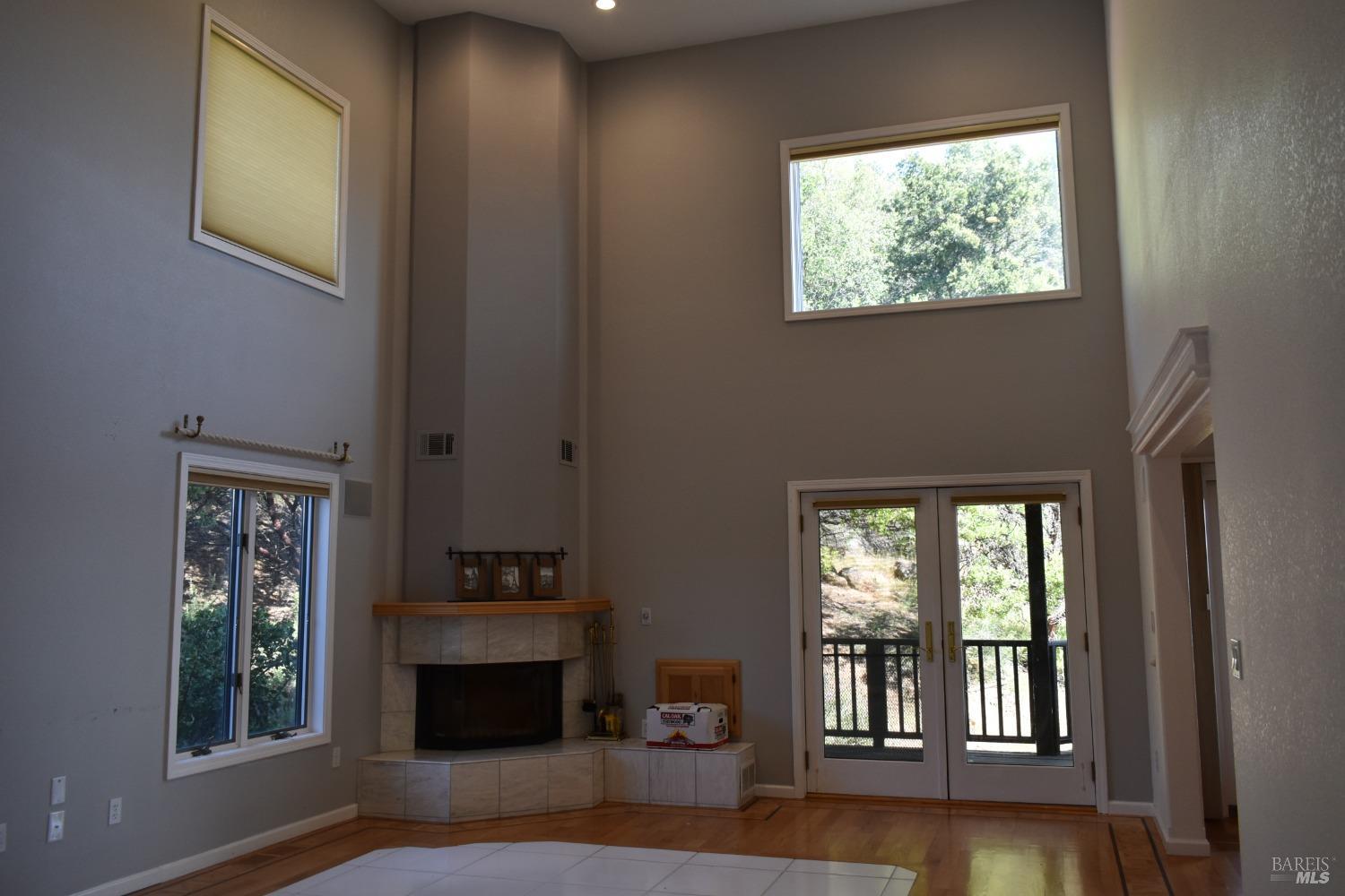 7490 Walnut Lane Lower Lake, CA 95457 - Photo 7 of 44 a living room with furniture and a fireplace next to a window