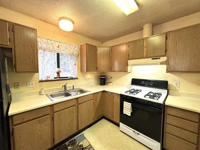 a kitchen with a stove a sink and a refrigerator