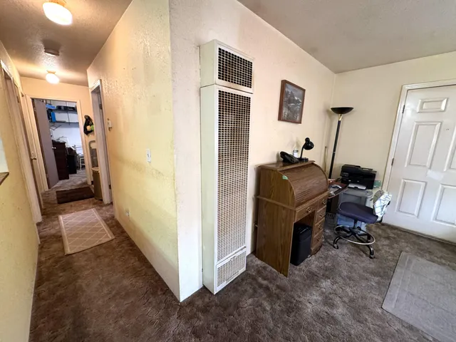 a bedroom with a bed couch and a window