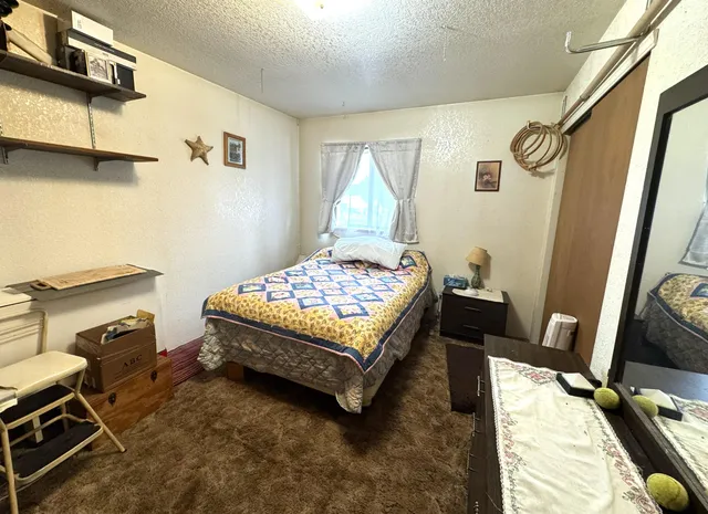 a bedroom with a bed and a mirror