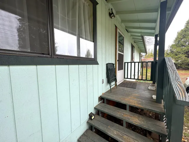 a living room with furniture a window and a flat screen tv