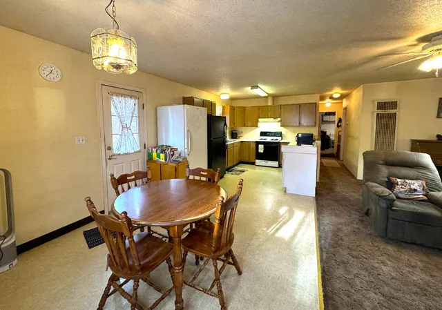a view of a dining room with furniture and a chandelier