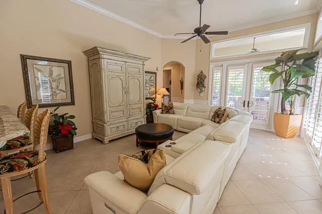 a living room with furniture a chandelier and a window