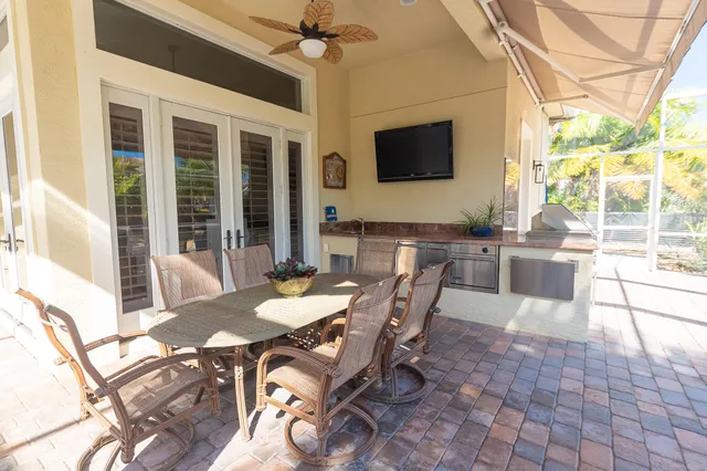 a view of a house with backyard and sitting area