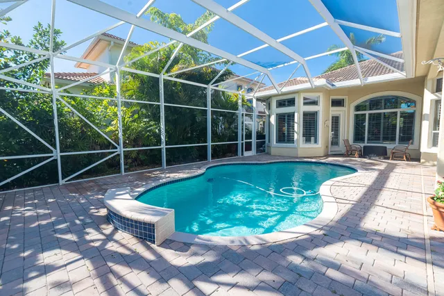 a view of a patio with table and chairs under an umbrella