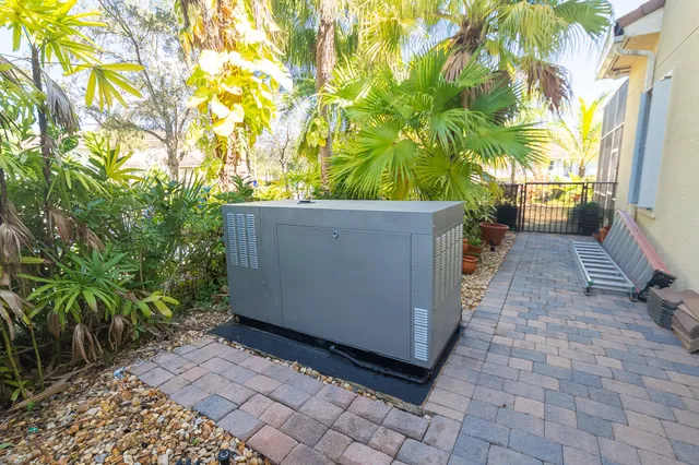 a front view of a house with garden and sitting area