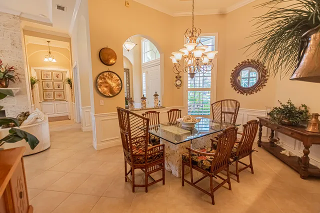 a dining room with furniture and a large window