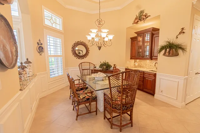 a view of a dining room with furniture and chandelier