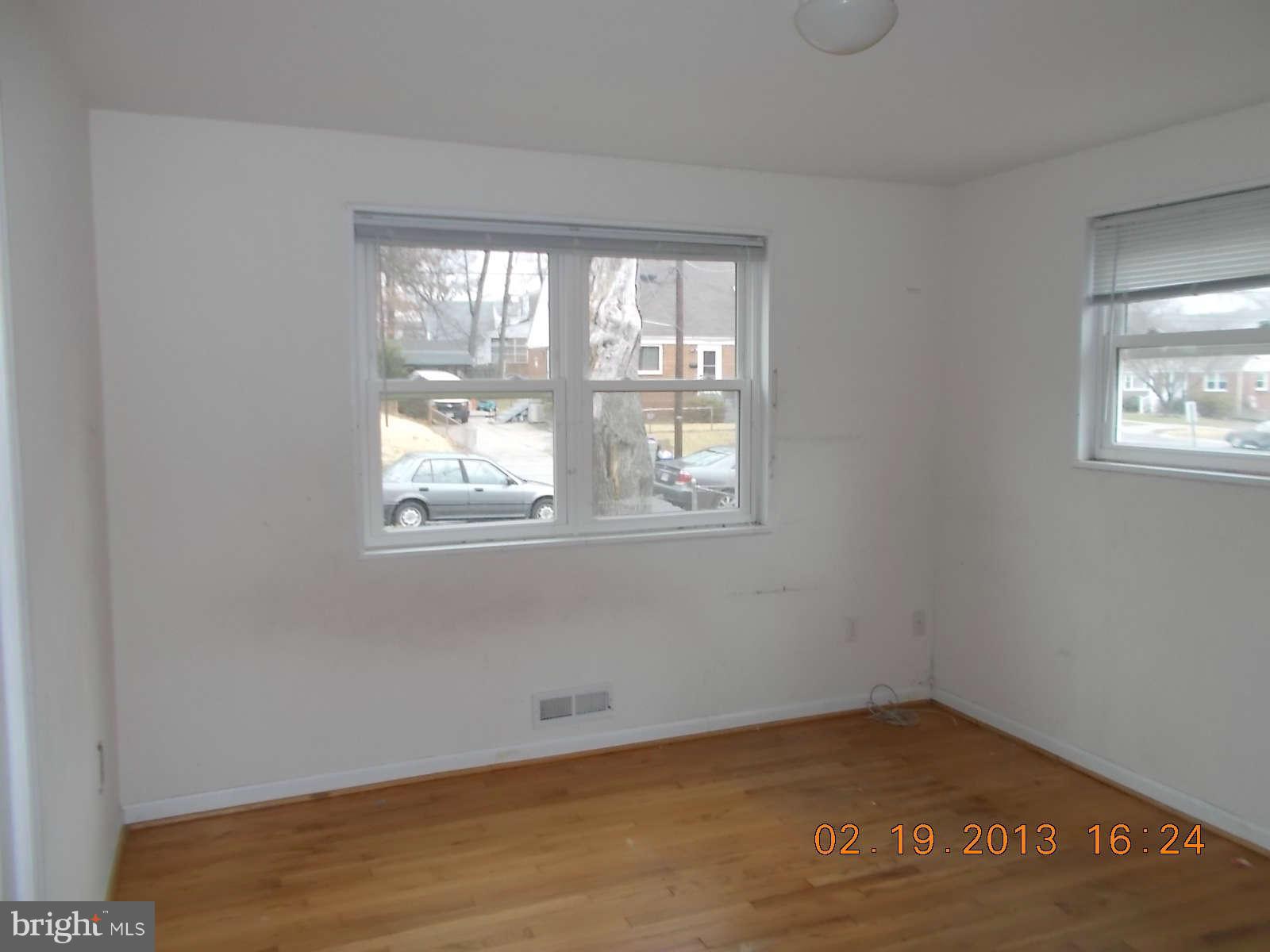 3302 Harrell Street Silver Spring, MD 20906 - Photo 11 of 18 a view of an empty room with wooden floor and a window