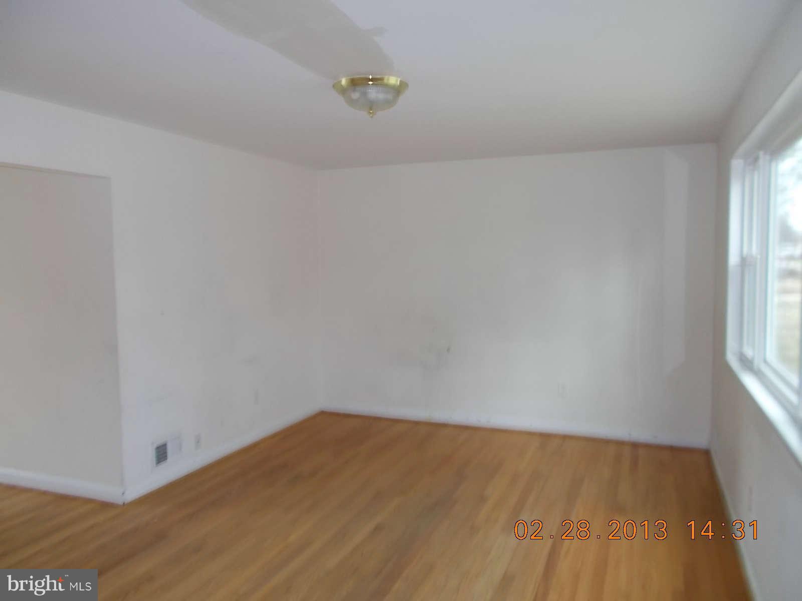 3302 Harrell Street Silver Spring, MD 20906 - Photo 3 of 18 a view of empty room with wooden floor and fan
