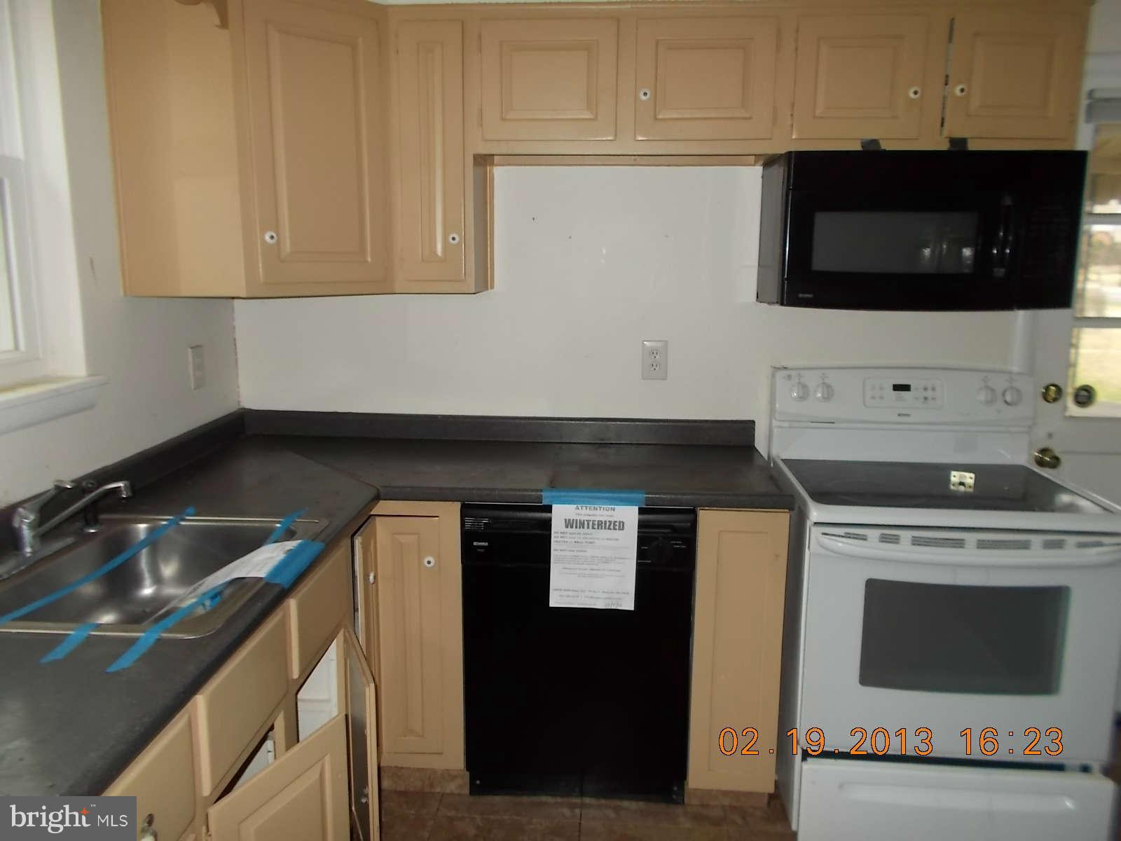 3302 Harrell Street Silver Spring, MD 20906 - Photo 4 of 18 a kitchen with a stove and a microwave