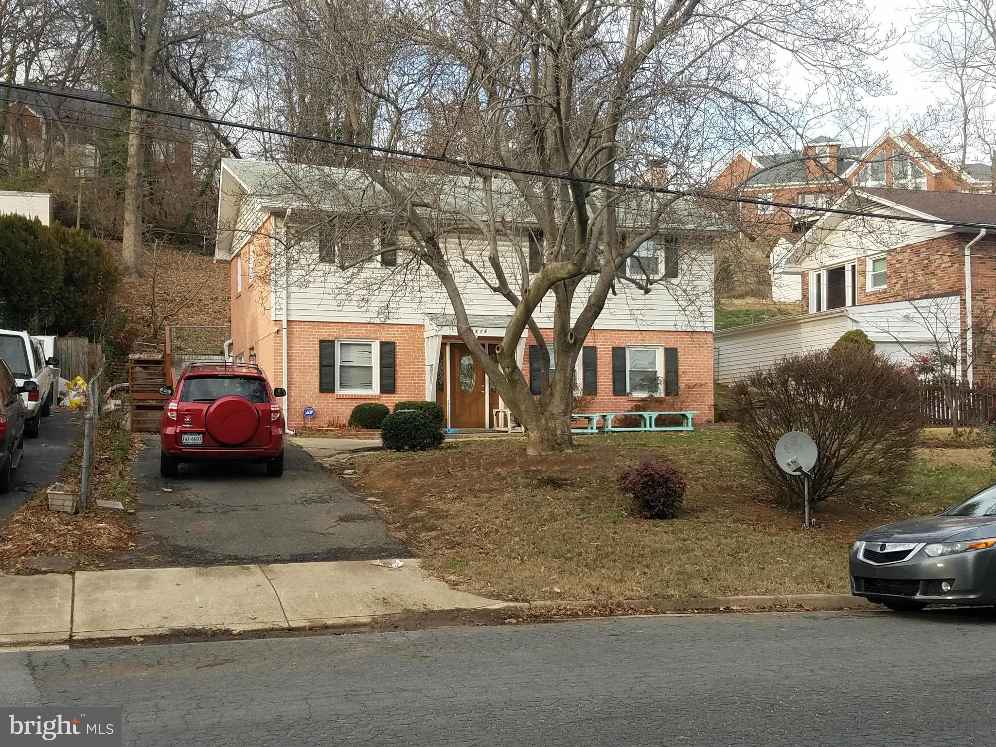 a view of a car parked in front of a house