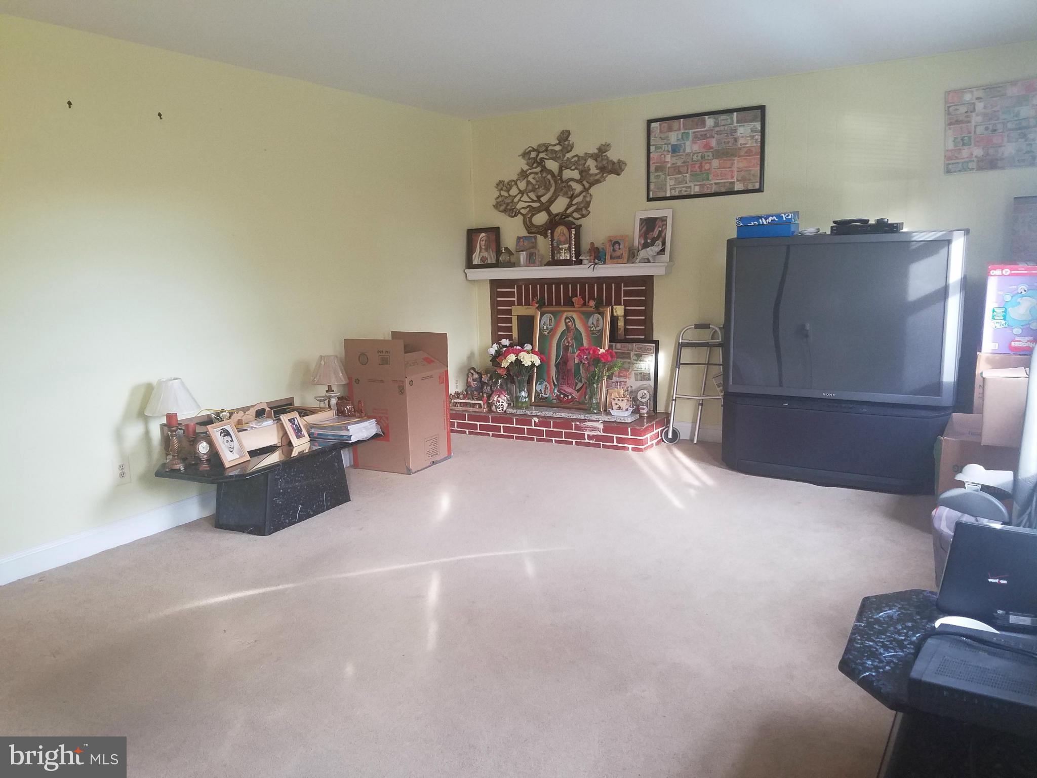 3116 Spring Drive Alexandria, VA 22306 - Photo 2 of 9 a living room with furniture and a fireplace