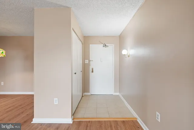 a view of a room with wooden floor and a hallway