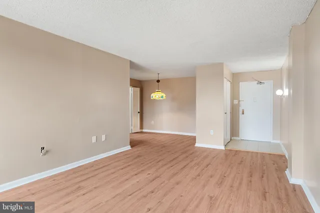 a view of an empty room and wooden floor