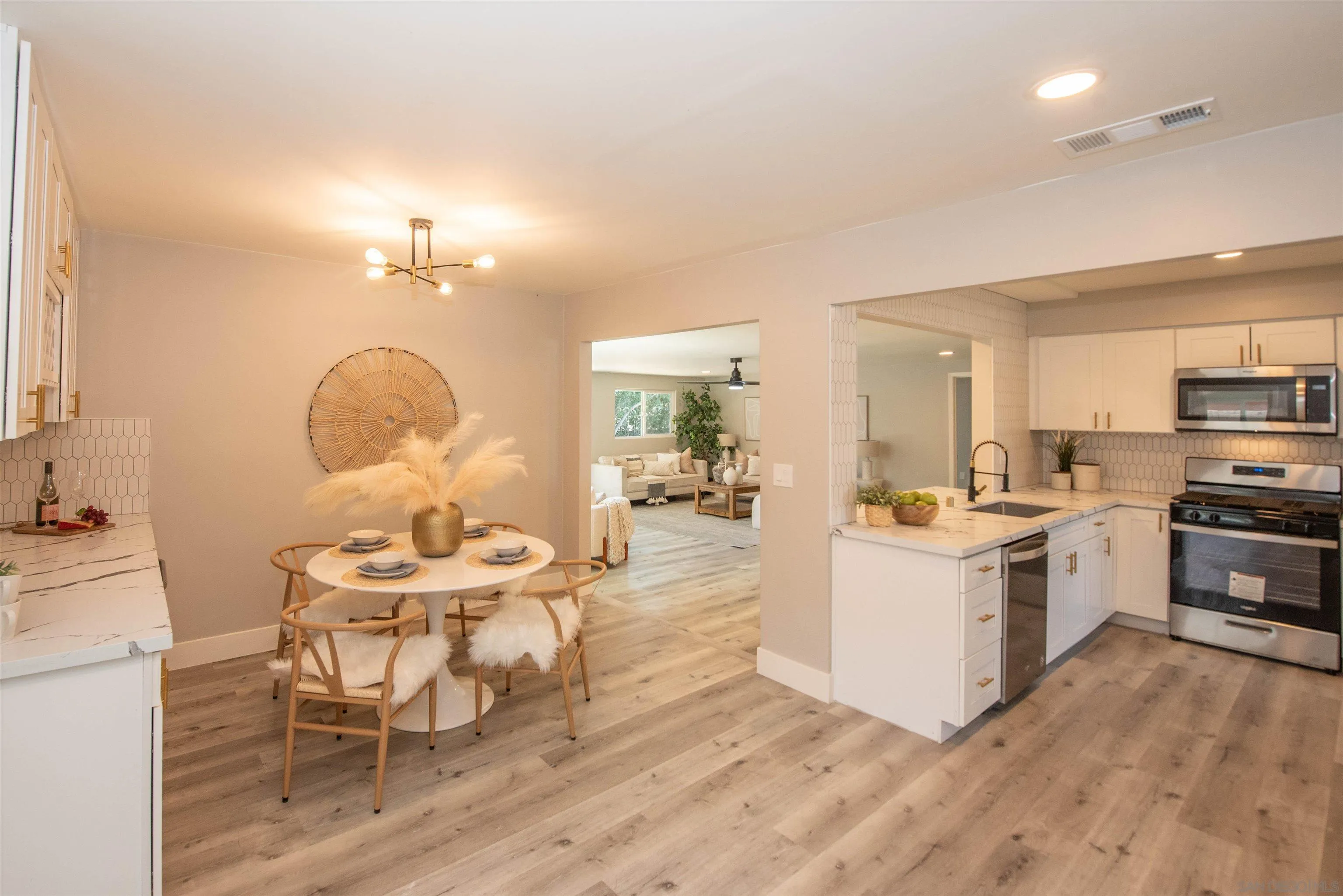 101 Monroe Street Oceanside, CA 92057 - Photo 12 of 40 a kitchen with a dining table chairs refrigerator and cabinets
