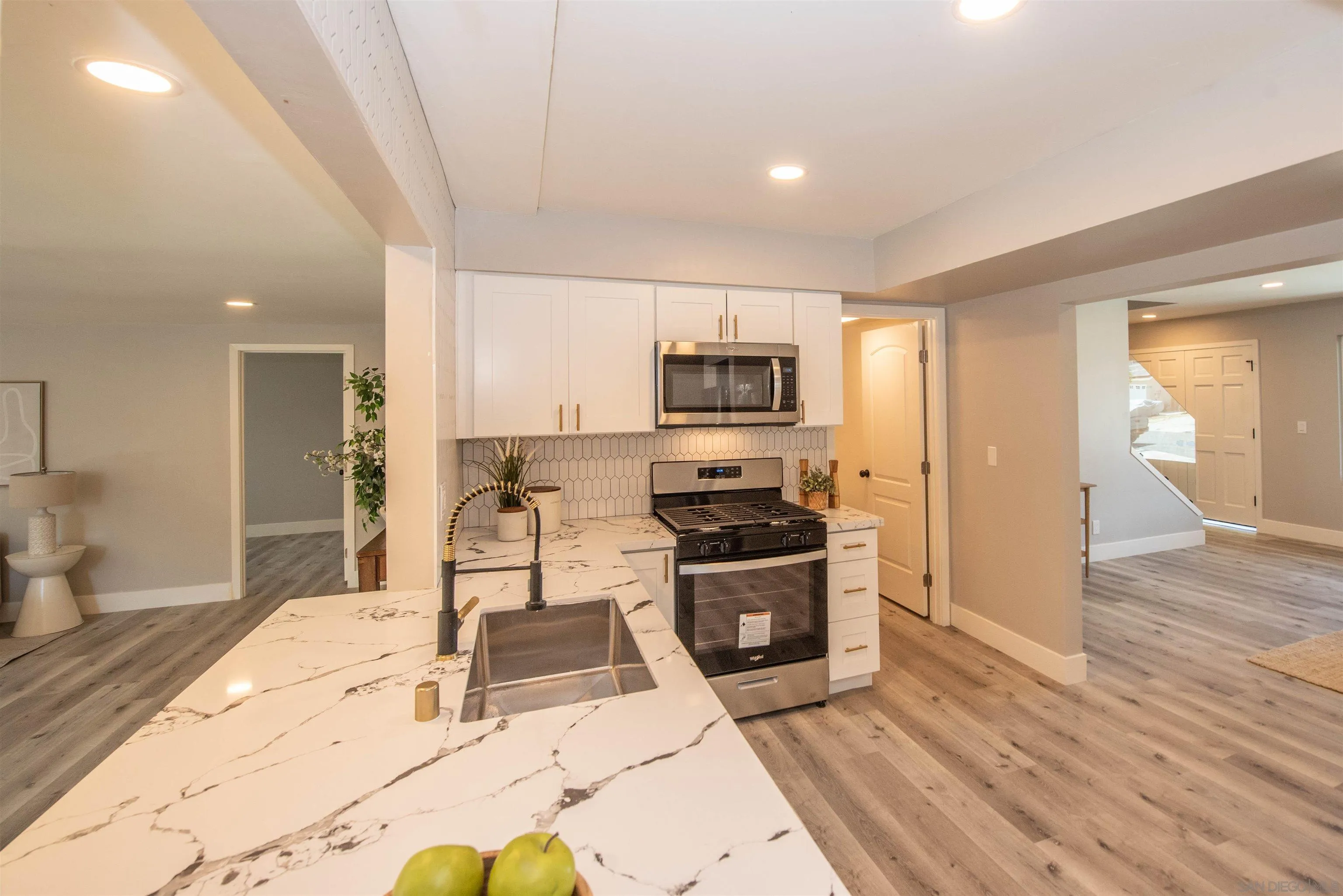 101 Monroe Street Oceanside, CA 92057 - Photo 13 of 40 a kitchen with stainless steel appliances kitchen island granite countertop a refrigerator and a stove top oven