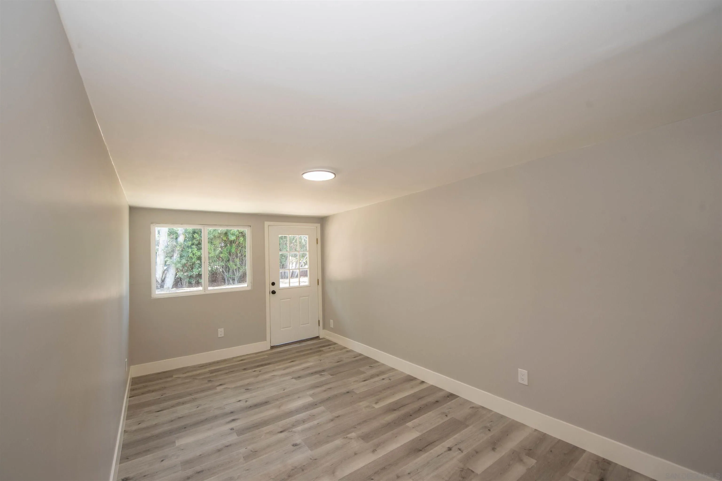 101 Monroe Street Oceanside, CA 92057 - Photo 19 of 40 an empty room with wooden floor and windows