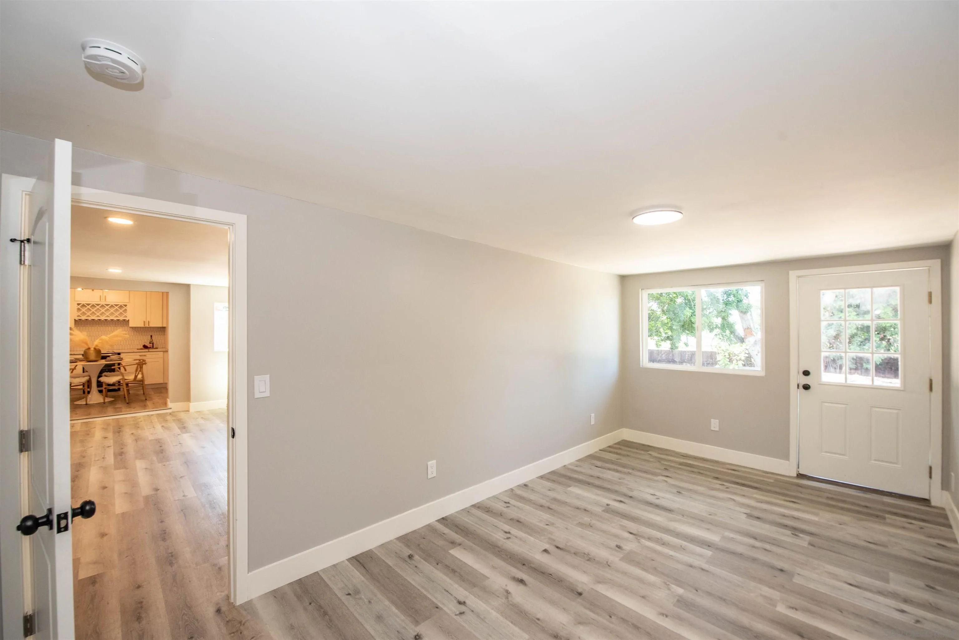 101 Monroe Street Oceanside, CA 92057 - Photo 20 of 40 an empty room with wooden floor and windows