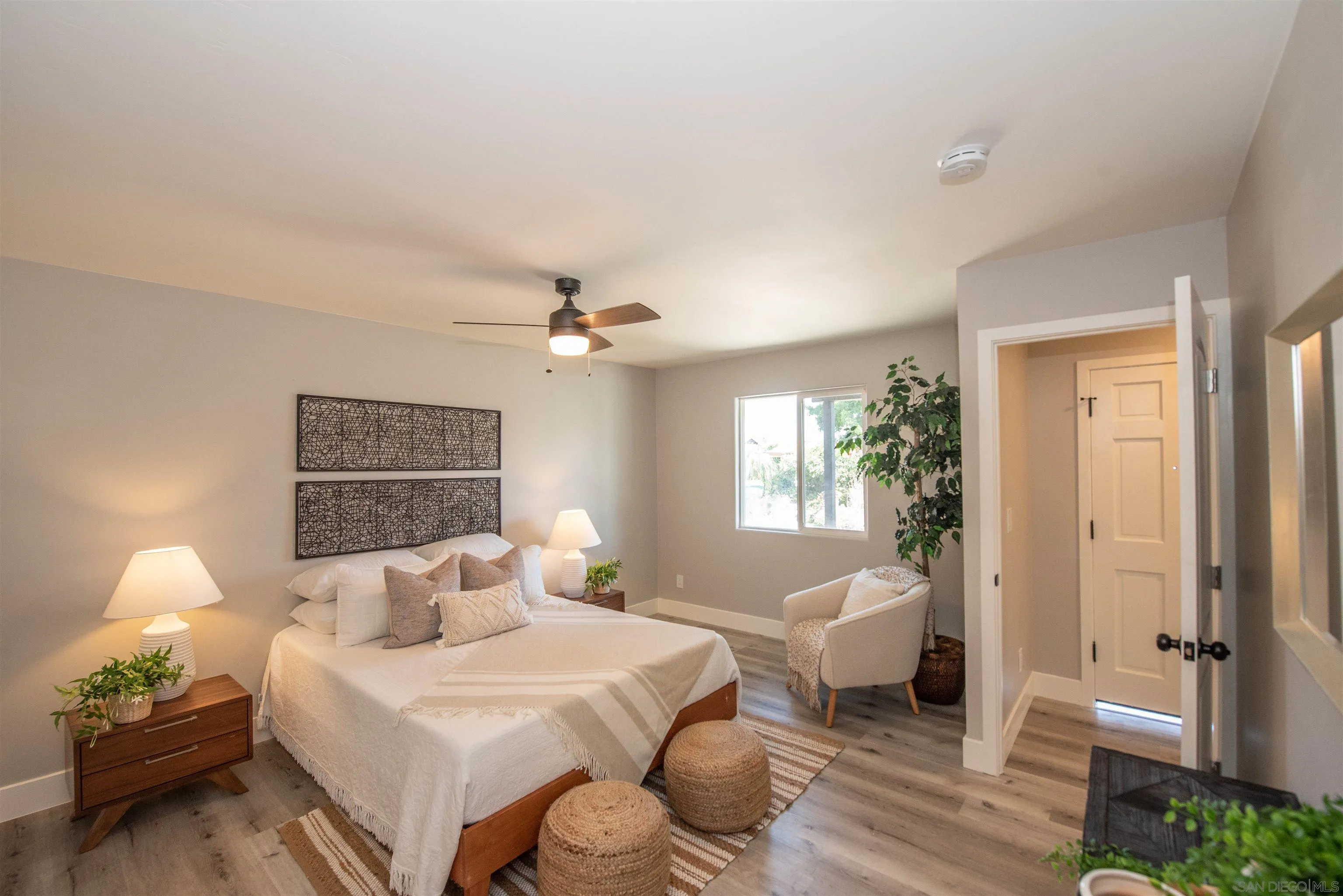 101 Monroe Street Oceanside, CA 92057 - Photo 23 of 40 a spacious bedroom with a bed and wooden floor