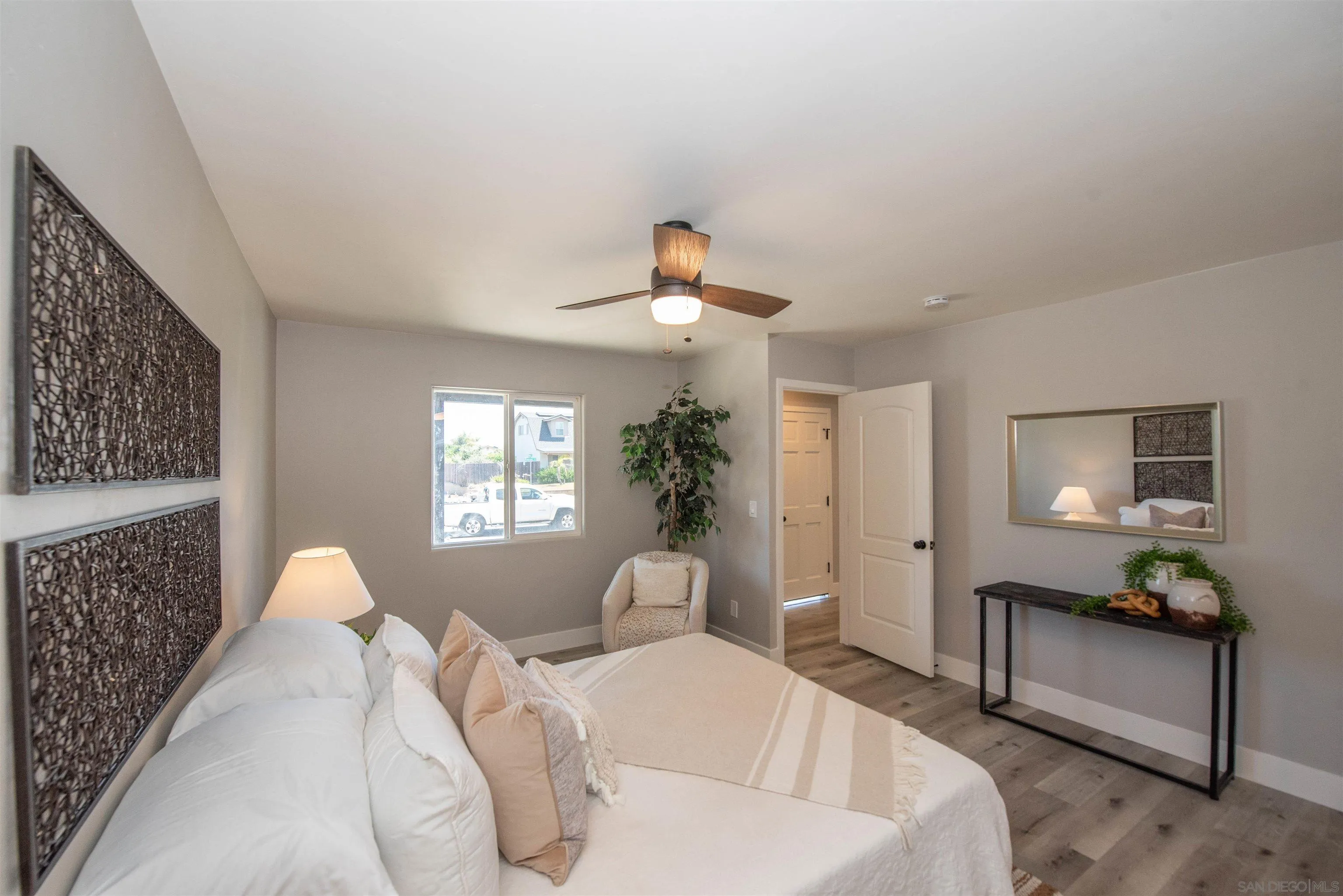 101 Monroe Street Oceanside, CA 92057 - Photo 25 of 40 a bedroom with a bed and a chandelier