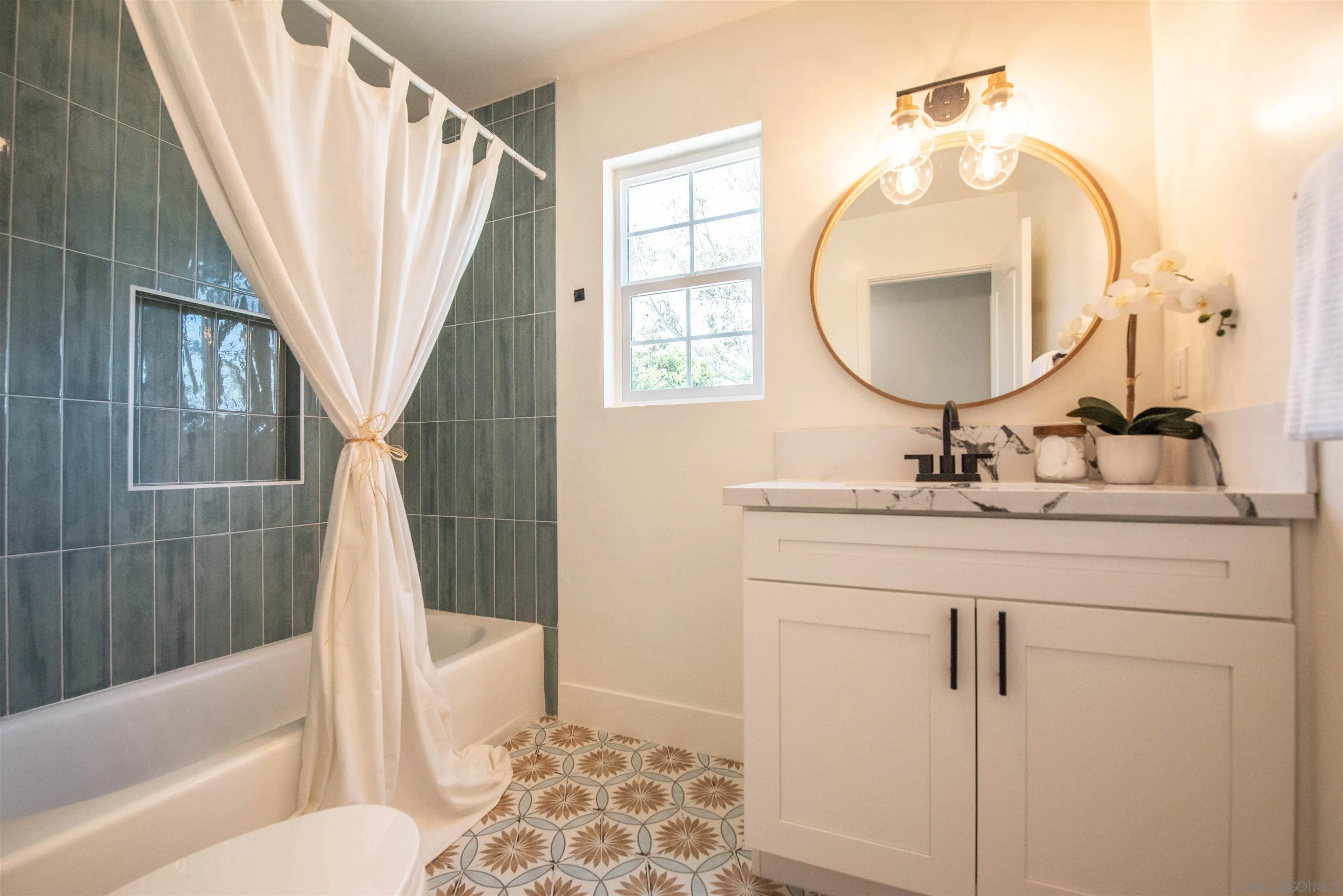 101 Monroe Street Oceanside, CA 92057 - Photo 32 of 40 a bathroom with a sink a toilet a mirror a vanity and bathtub