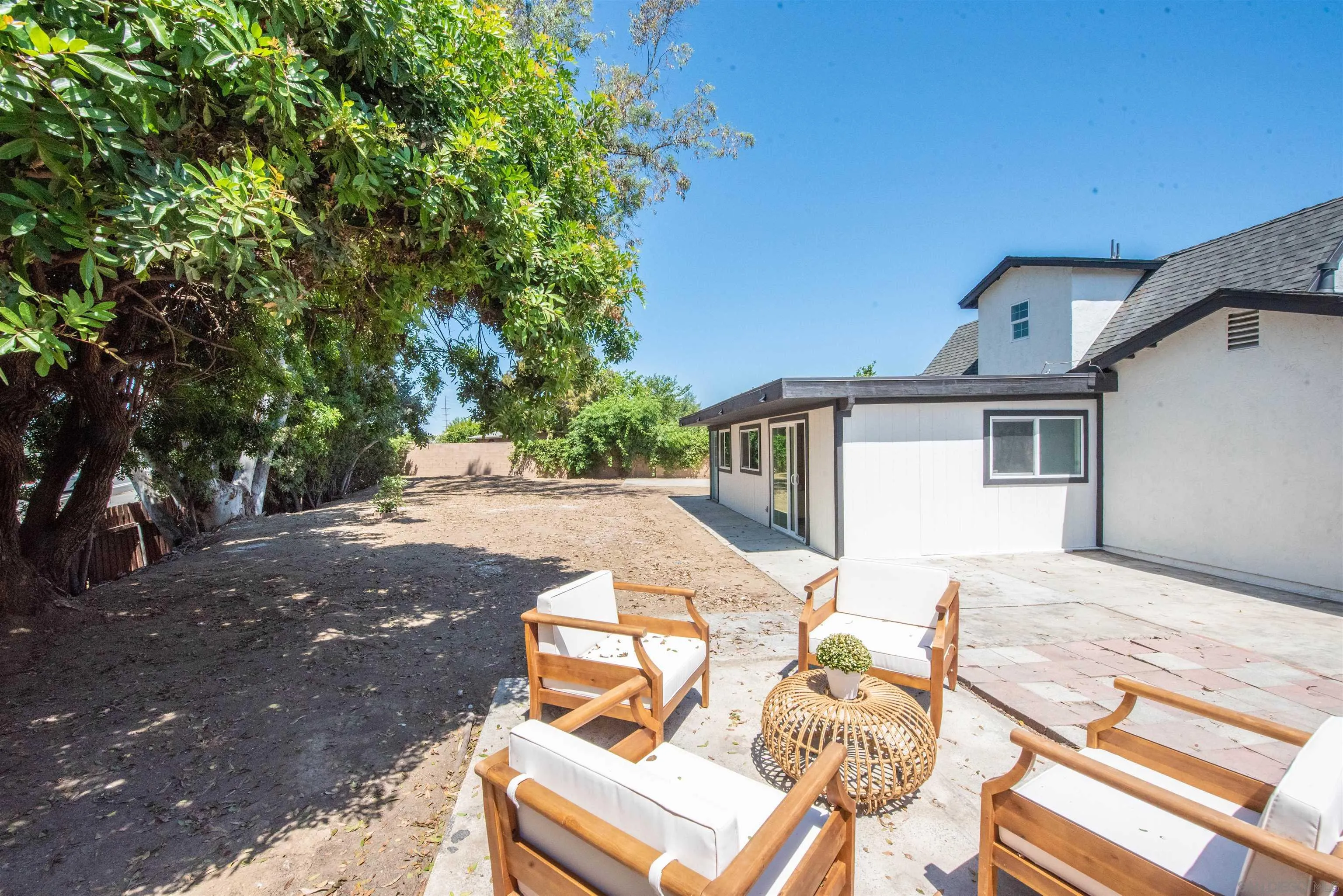 101 Monroe Street Oceanside, CA 92057 - Photo 34 of 40 a view of a patio with table and chairs with wooden floor and fence