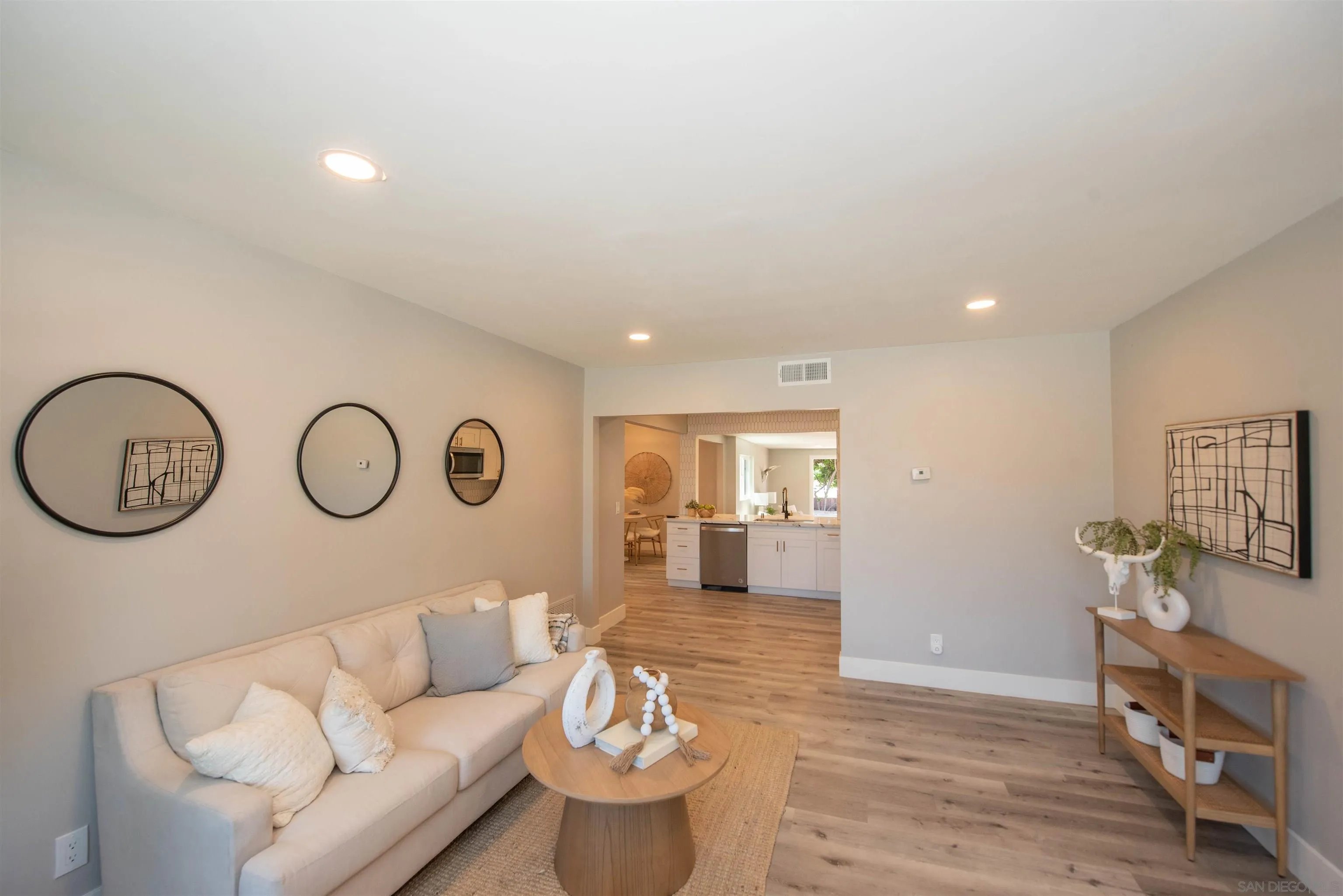 101 Monroe Street Oceanside, CA 92057 - Photo 8 of 40 a living room with furniture a stove a mirror and wooden floor