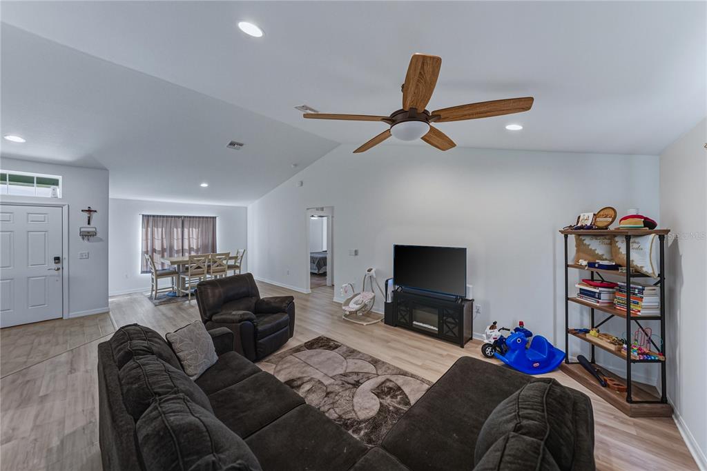 4514 Adrienne Street Sebring, FL 33872 - Photo 18 of 55 a living room with furniture a flat screen tv and a couch