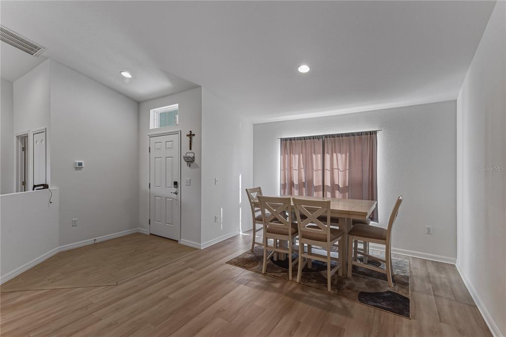 4514 Adrienne Street Sebring, FL 33872 - Photo 21 of 55 a view of a dining room with furniture and wooden floor